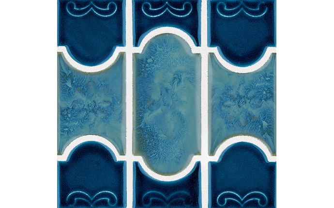 Close-up of mosaic tile showing navy border and botanical pattern