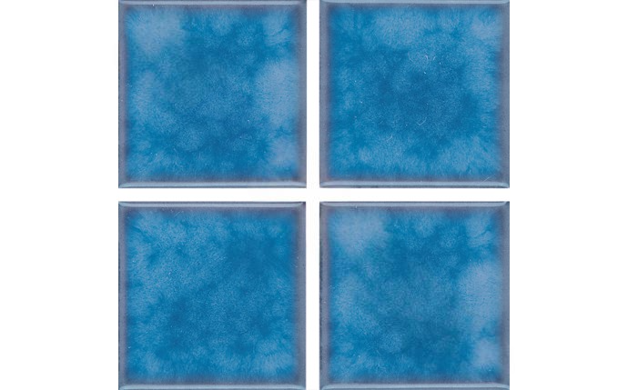 Styled installation of Akron 3x3 field tile in a serene outdoor pool