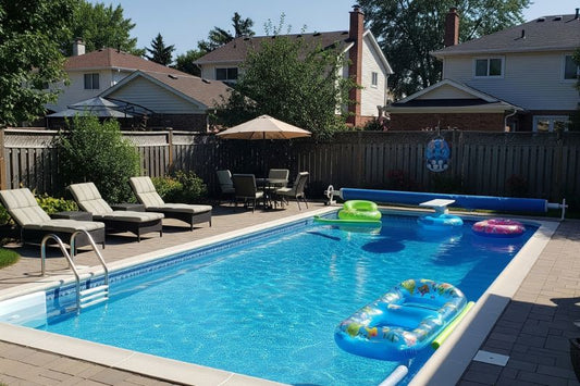 Backyard pool being cleaned and prepared after removing winter cover for opening