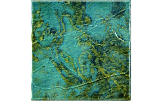 Close-up of watercolor-like aqua and gold tile surface